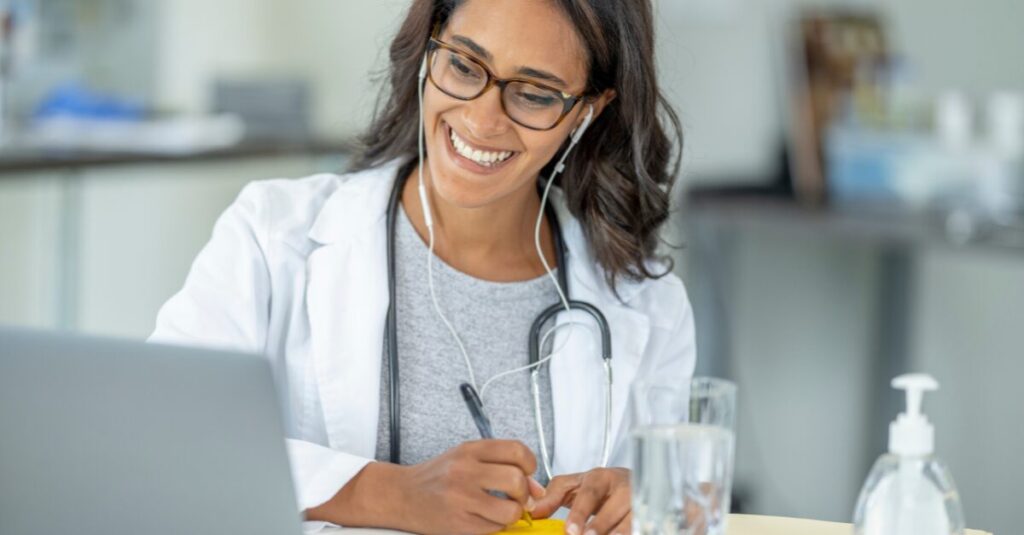  Healthcare professionals on computers looking happy and satisfied